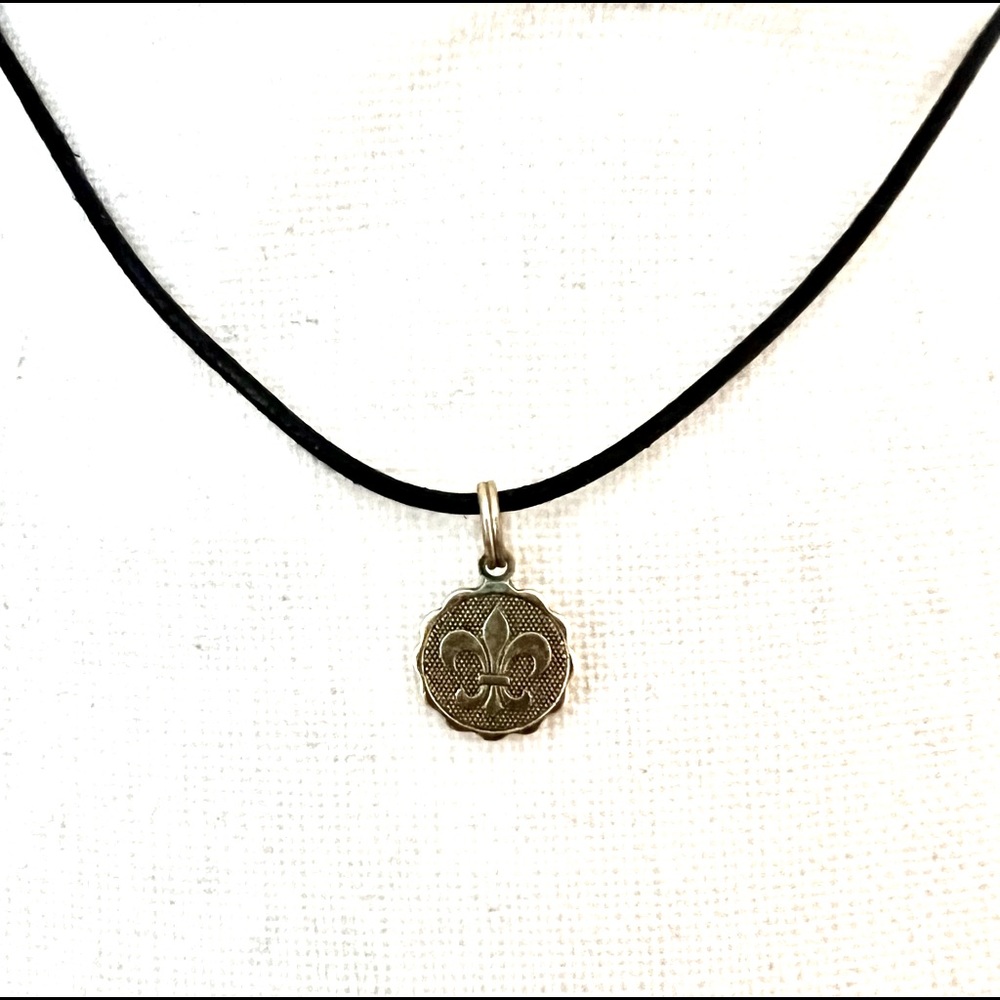 Brass fleur de lis pendant on leather necklace